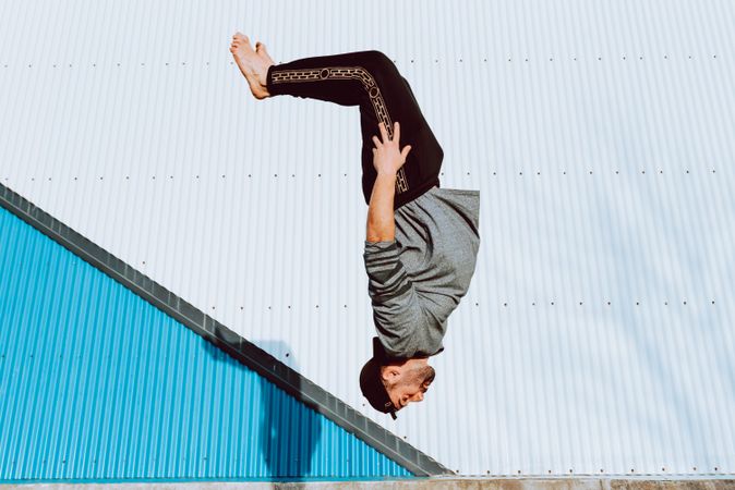 Trendy male flipping on street