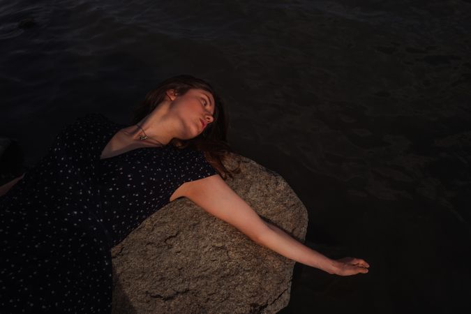 Sensual woman resting on lake shore