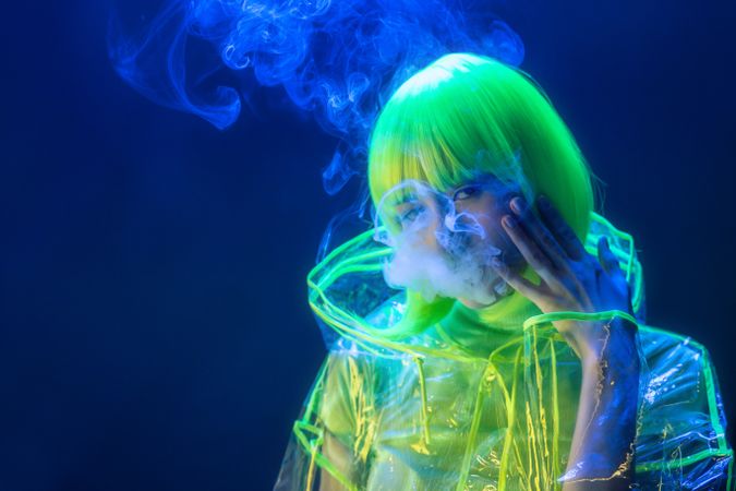Asian woman smoking in fluorescent light