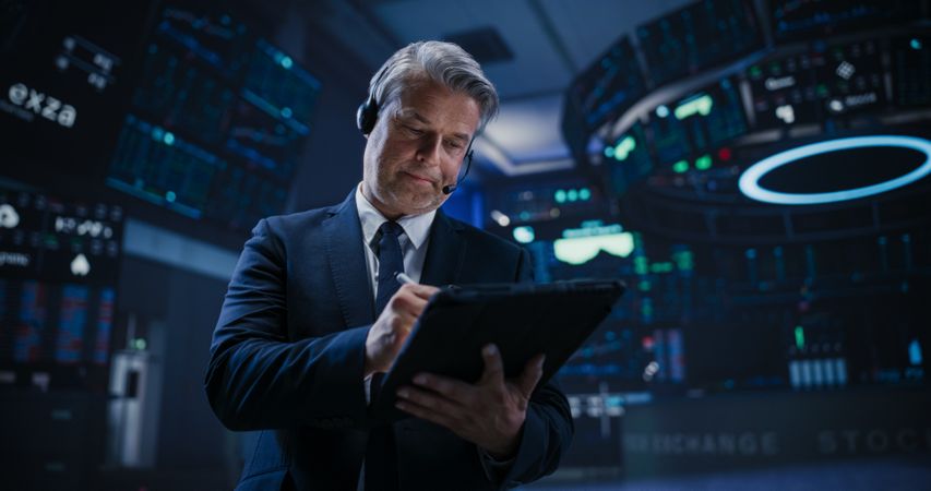 Low Angle Portrait of a Successful Stock Exchange Manager Working in Modern Office.