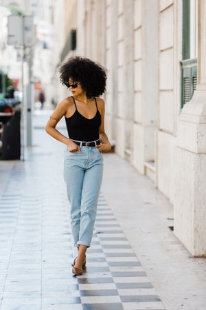 Cheerful Black female in dark sunglasses