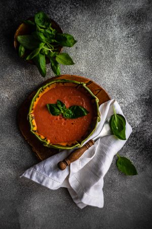 Traditional tomato soup with basil leaves