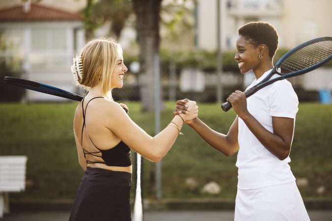 Tennis players shaking hands at net