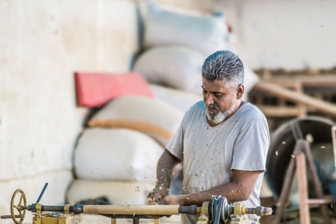 Man using woodworking machine at workplace