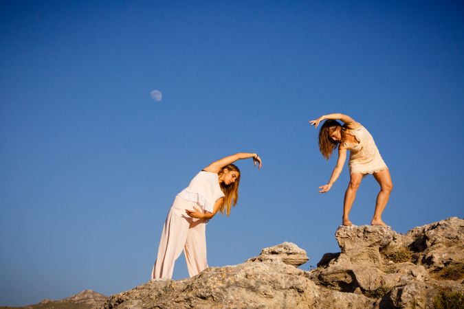 Young women posing on stones