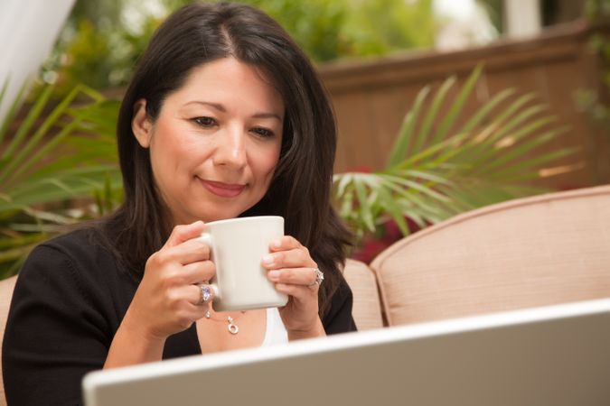 Hispanic Woman with Coffee and Laptop
