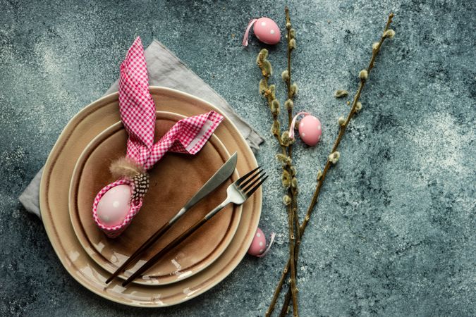 Easter holiday table setting with pink decorations with pink napkin
