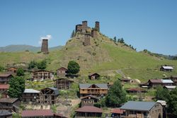 Tall old defensive building in majestic mountains in summer sunny day