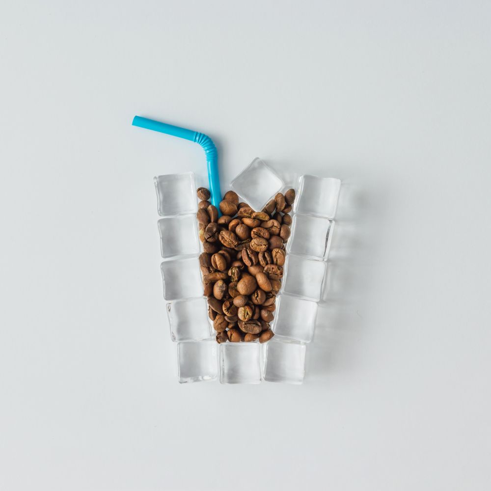 Cup of ice coffee made of ice cubes and coffee beans