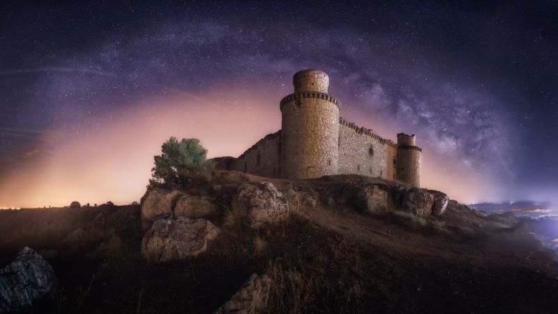 Ruined fort under starry night sky