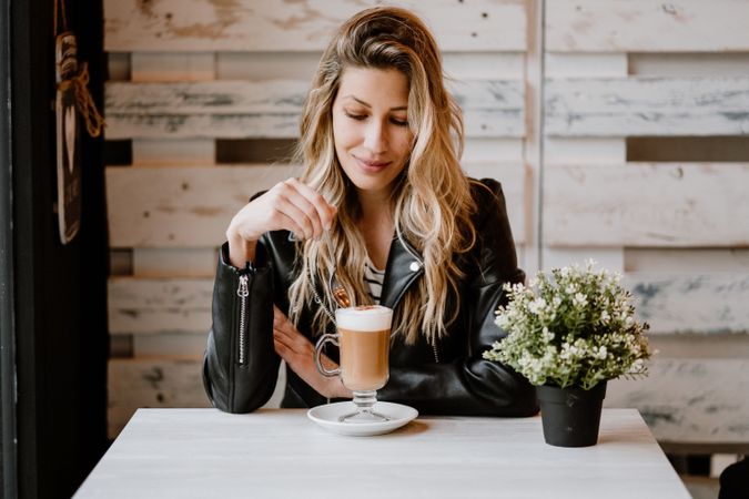 Woman drinking coffee from a glass
