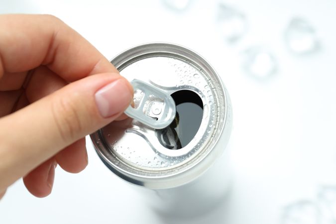 Female hand open can with drink, close up