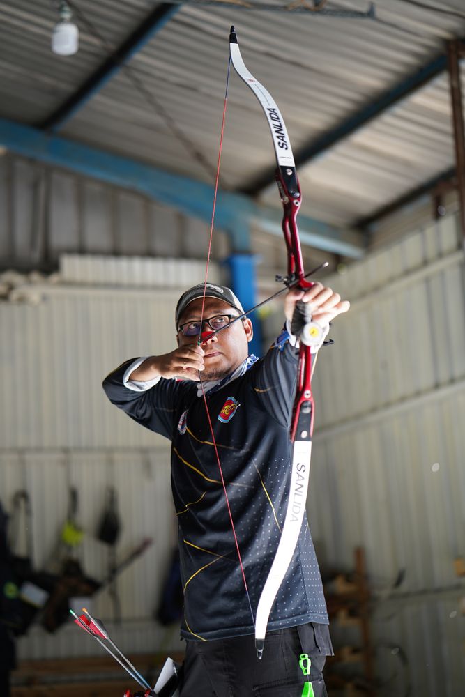 Man about to shoot with bow and arrow