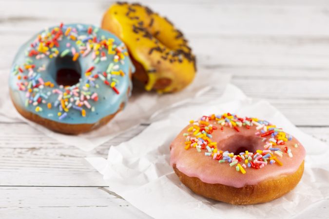 Delicious assorted colorful donuts on the table.
