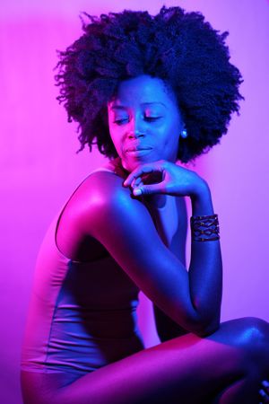 Female in vest in purple blue studio shot