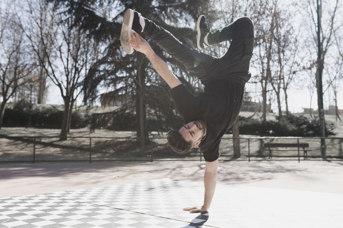 Man dancing break dance in park