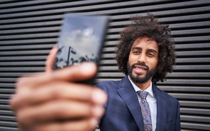 Joyful man taking selfie and smiling