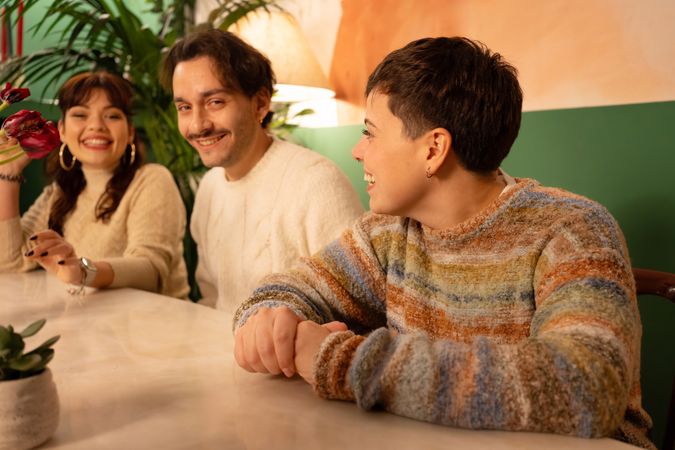 Group of happy diverse friends enjoying a cozy evening together in a bar
