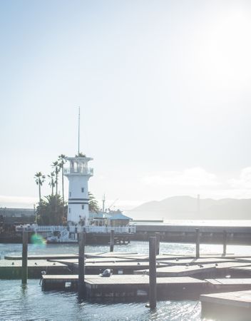 Beacon near embankment of sea in sunny weather