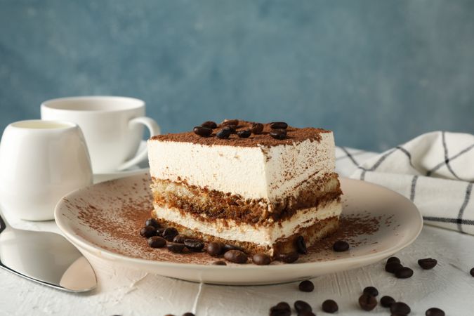 Composition with plate of tasty tiramisu on light background. Delicious dessert