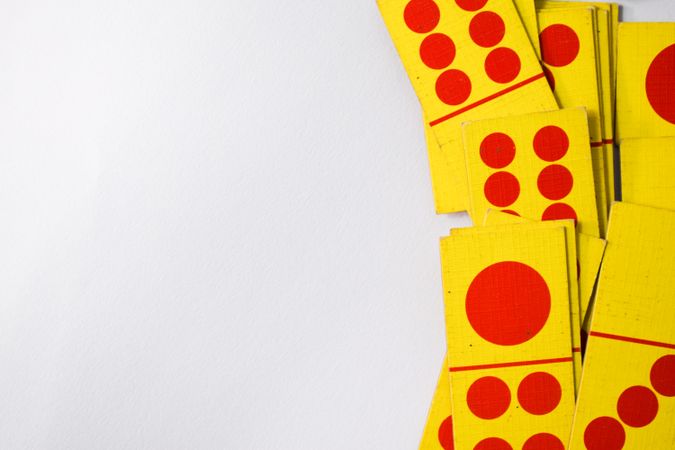 Looking down at red and yellow domino playing cards with space for text