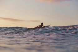 woman on surf board floating on water