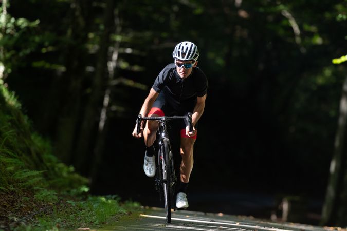 Professional cyclist riding bike in park