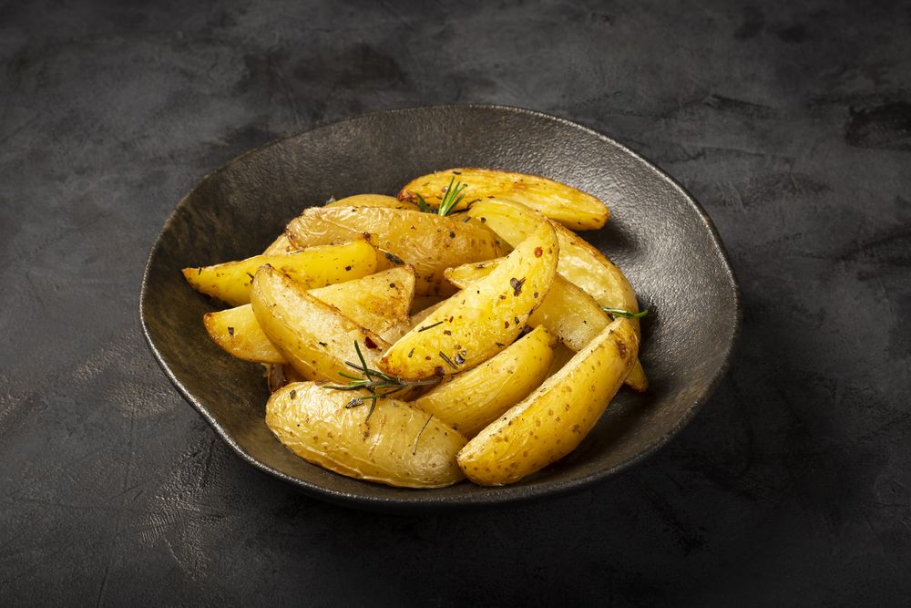Roasted potatoes with rosemary on the plate.