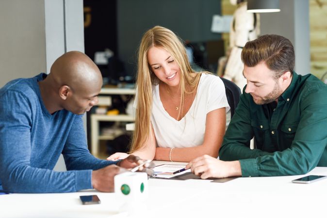 Multi-ethnic co-workers going through graphs at work