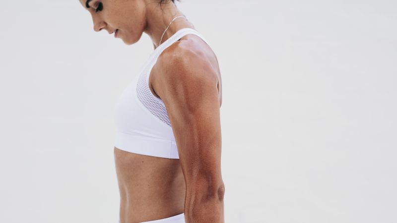 Cropped shot of woman’s toned arm and midsection