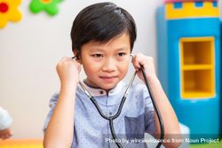 Cute Asian boy playing doctor bGgMab