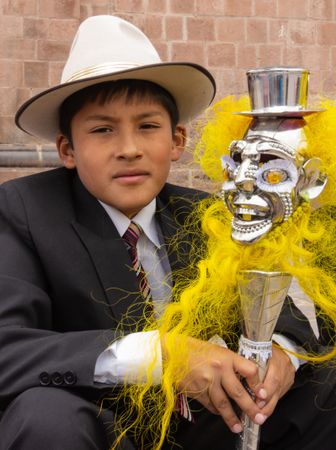 Peru - January, 02 2012: Schoolboy with fancy staff looking at camera