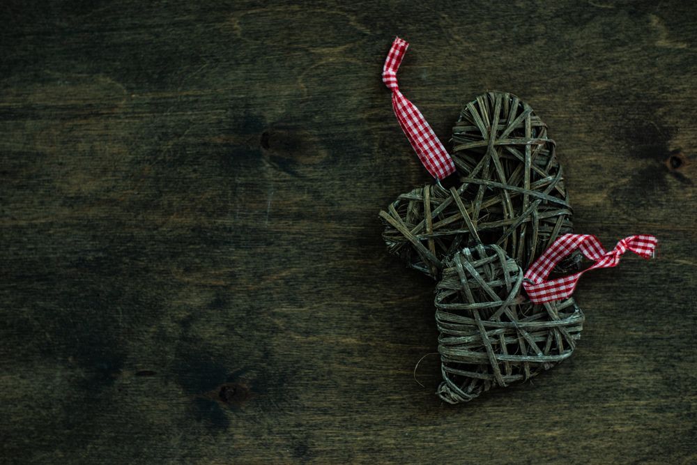 Valentine's day concept of thatched heart shaped decorations on wooden table