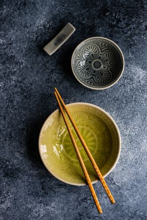 Top view of elegant bowls with chopsticks