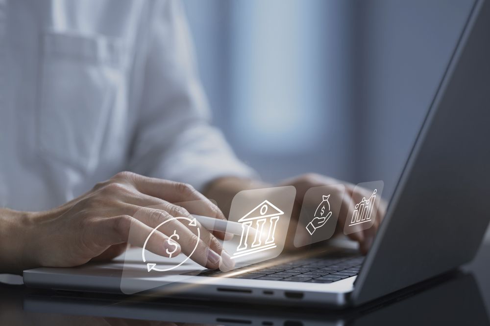 Businessman using laptop analyzing sales data and economic