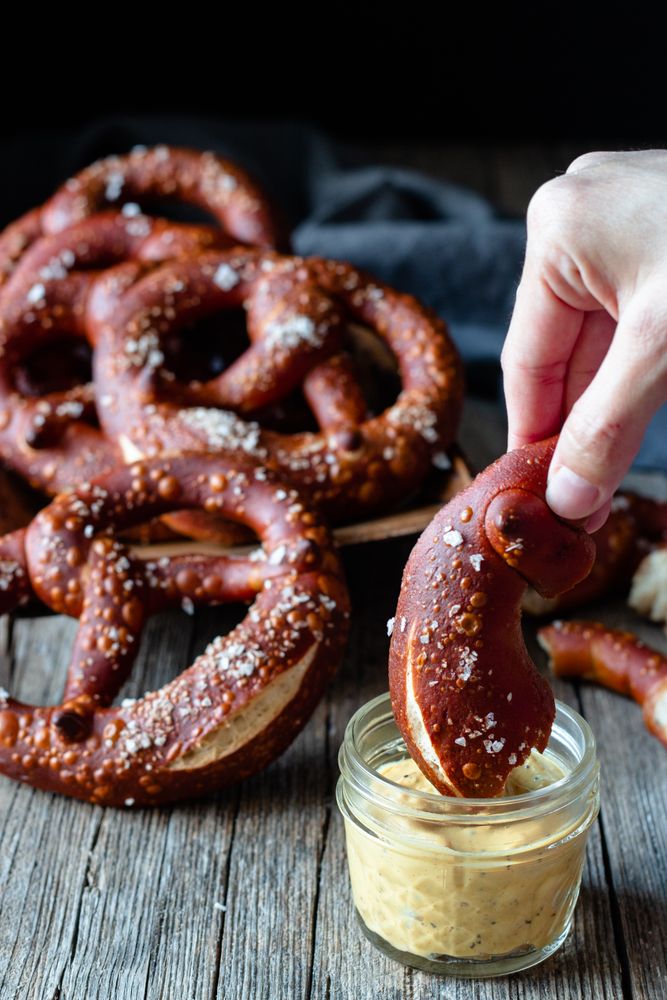 Faceless person eating delicious pretzels