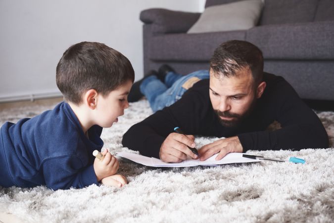 Father and son drawing on floor