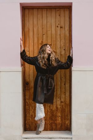 Laughing female near wooden door