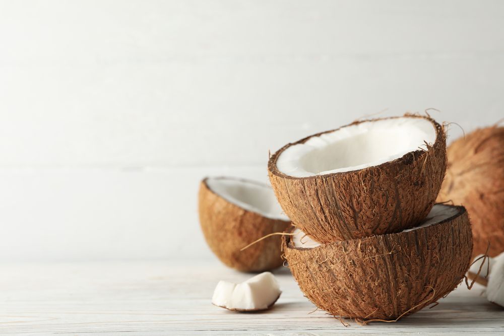 Coconut on wooden background, close up. Tropical fruit