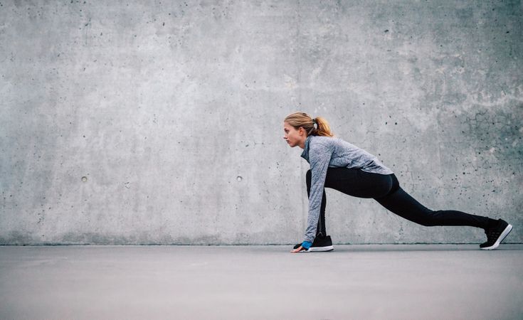 Side view of woman stretching before workout