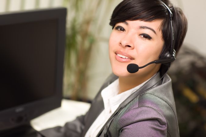 Young Woman Smiles Wearing Headset