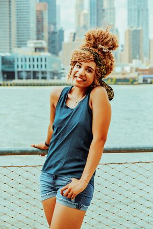 Happy Black woman at waterfront in Brooklyn with Hudson River in background