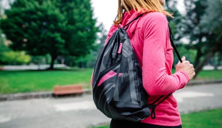 Unrecognizable sportswoman with backpack going to the gym