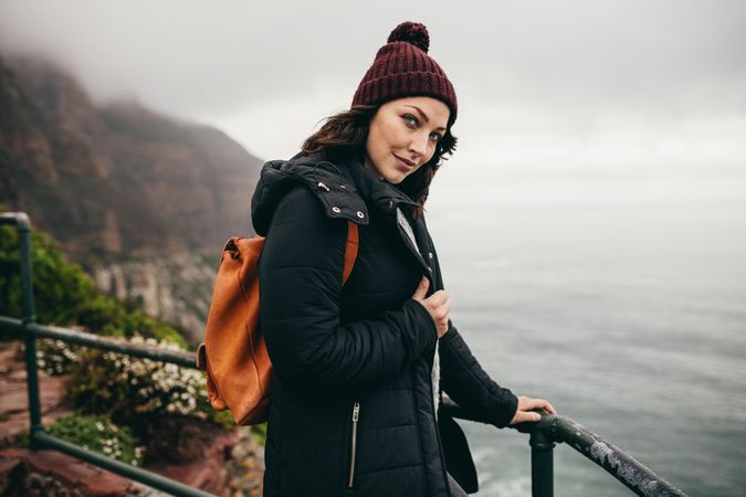 Woman on vacation  at cliff observation point on a winter day
