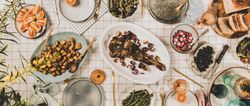 Flat-lay of Mediterranean table setting, with glassware, wide composition