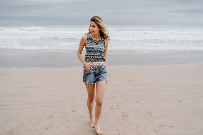 Happy female posing on sandy beach