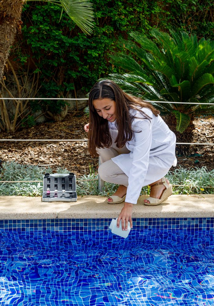 Safety inspector taking water sample from pool
