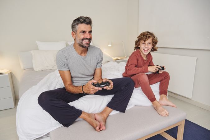 Happy man and child with gamepad