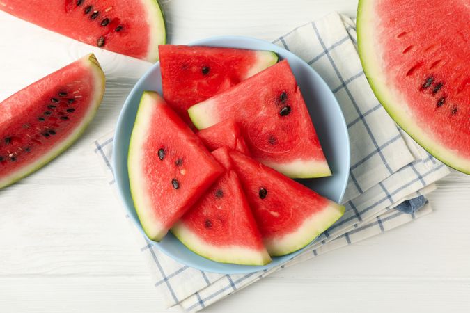 Composition with plate of fresh watermelon on wooden background, top view