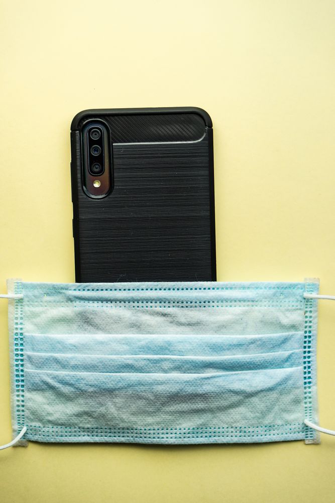 Covid-19 virus concept with facemask and phone
